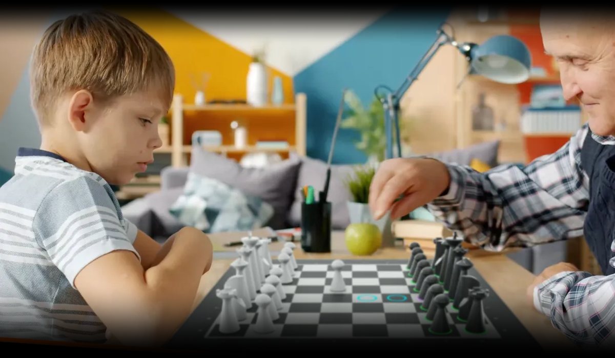A grandparent and child playing on a GoChess board at home
